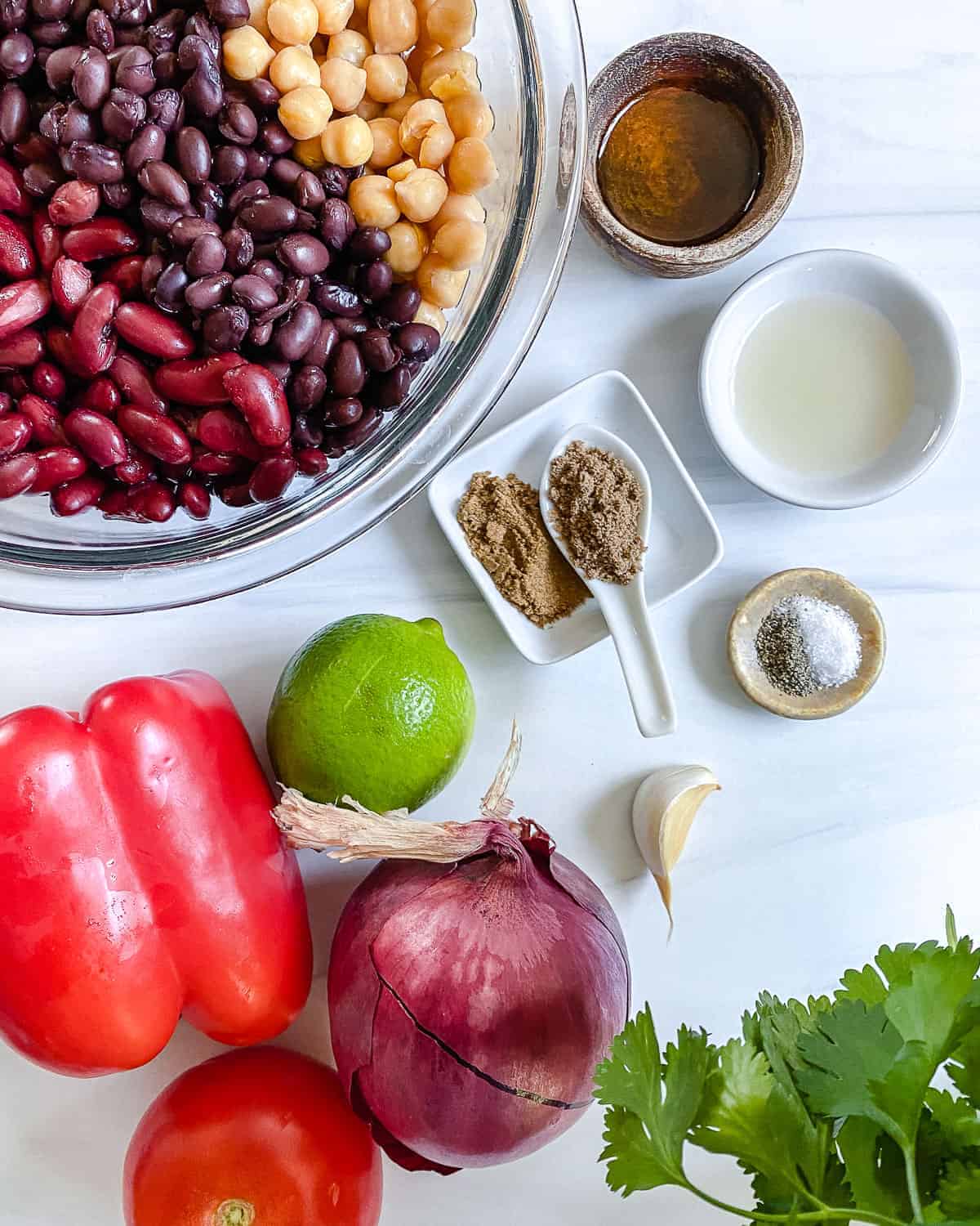 ingredients for mixed bean salad against a white background