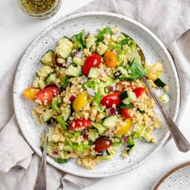 completed Vegan Greek Millet Salad on a white plate against a light background