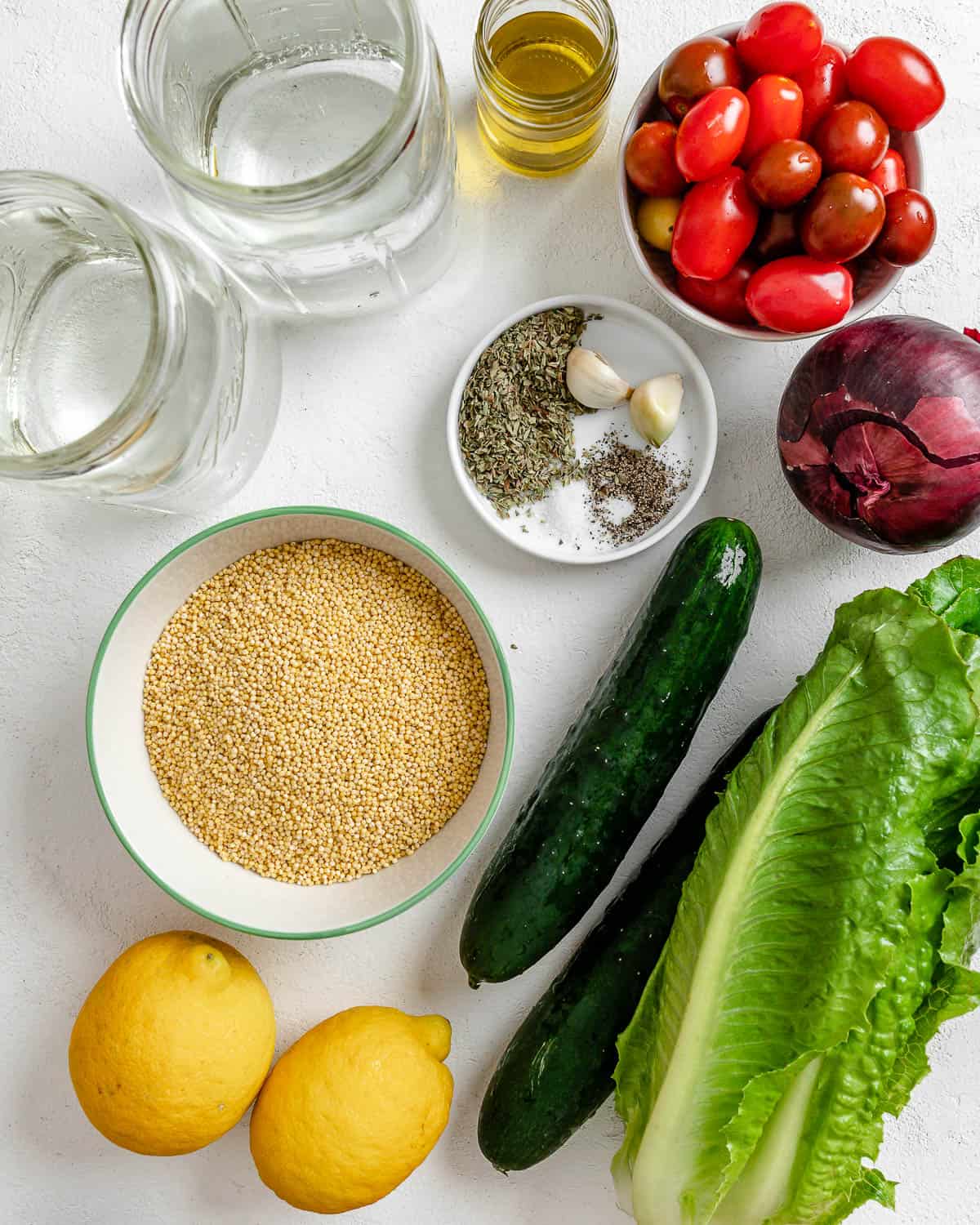 ingredients for Vegan Greek Millet Salad measured out against a white background