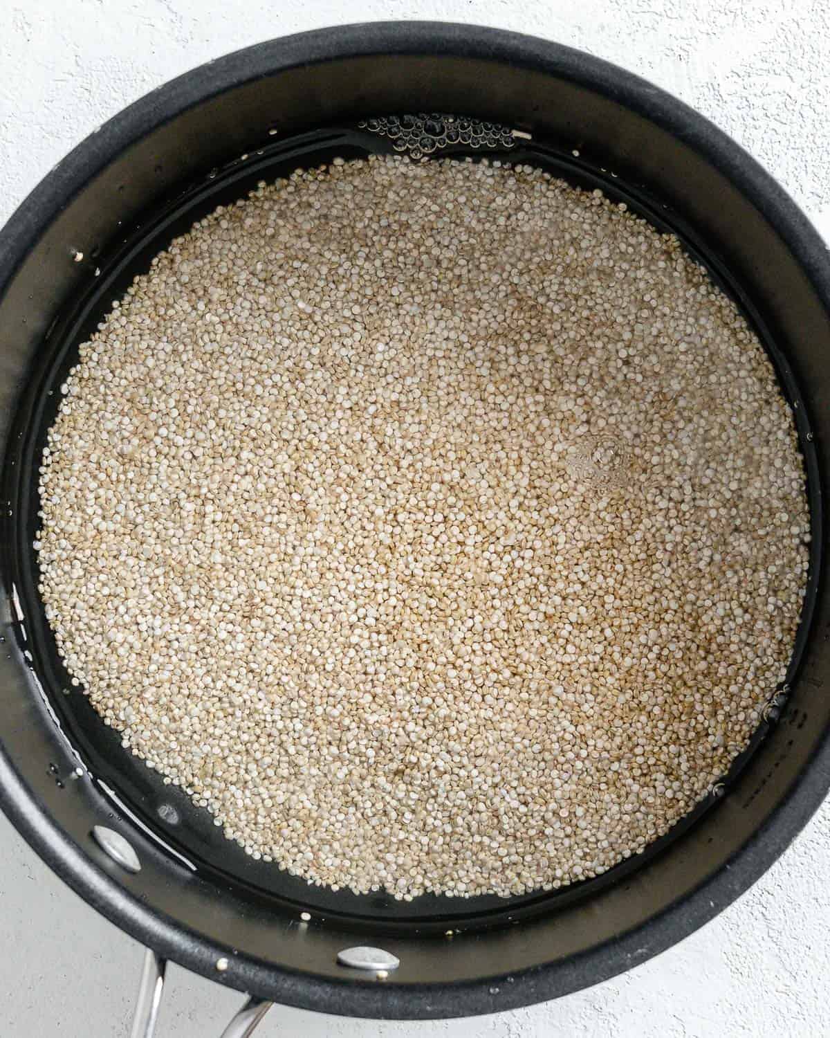 process shot of quinoa in a black pot