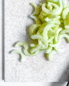 process for Soba Salad with Sunomono-Style Cucumbers with sliced cucumber on cutting board