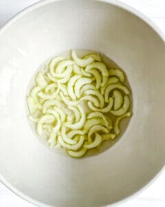 cucumber in marinade white bowl 