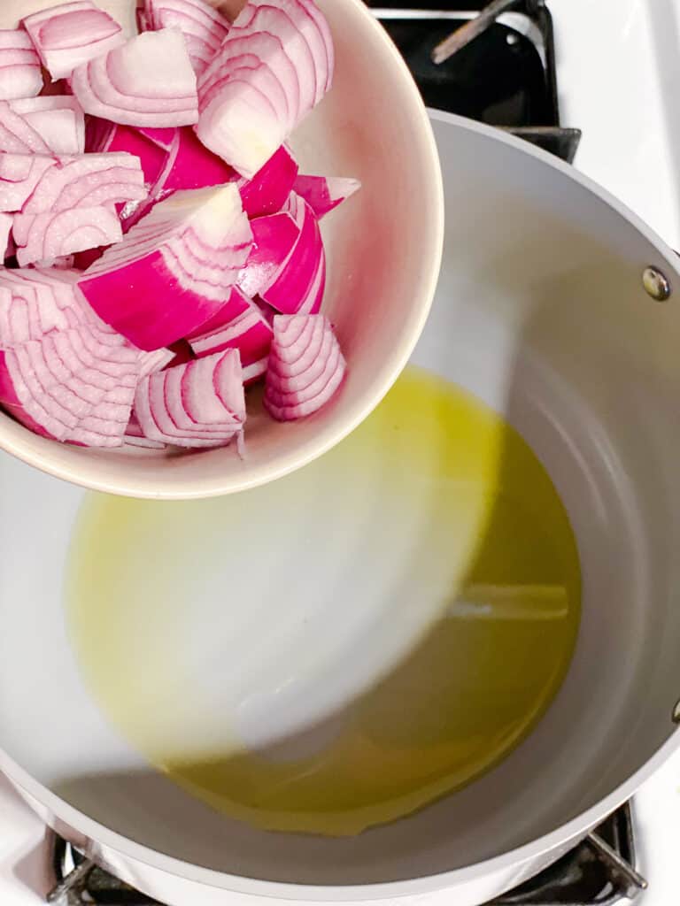 process shot of adding onions to pot