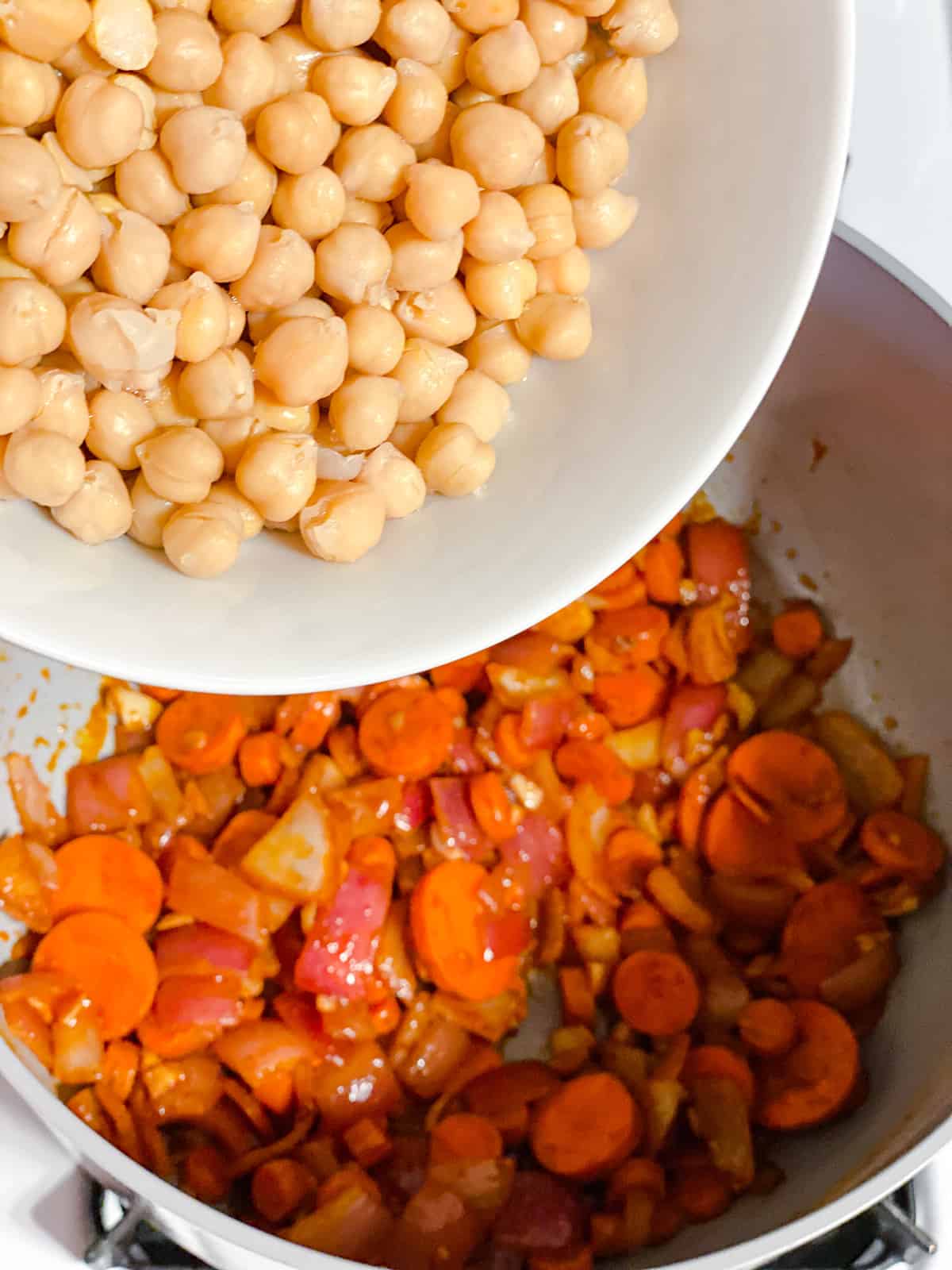 process shot of adding chickpeas to pot