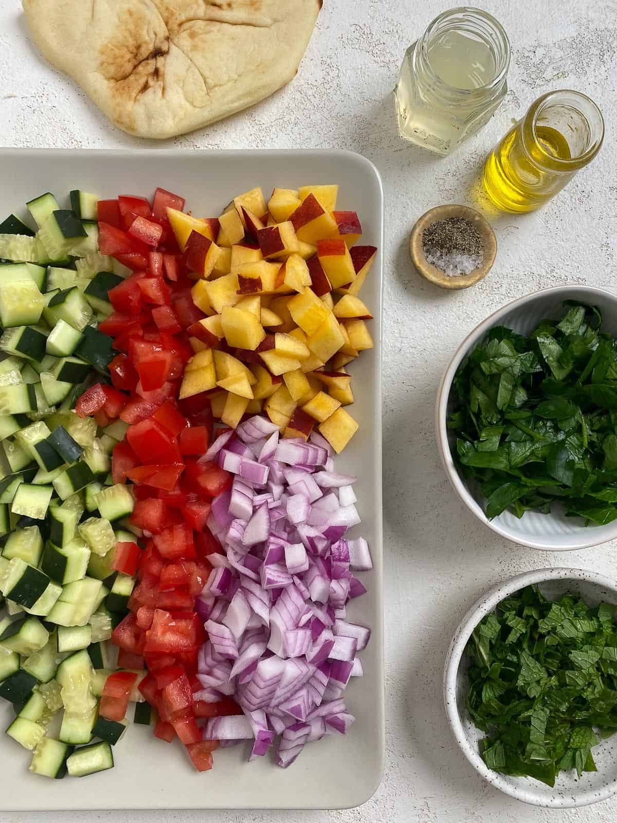 ingredients for Easy Summer Fattoush Salad measured out and sorted in bowls and on a tray