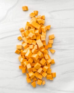 raw cubed butternut squash on a white marble surface