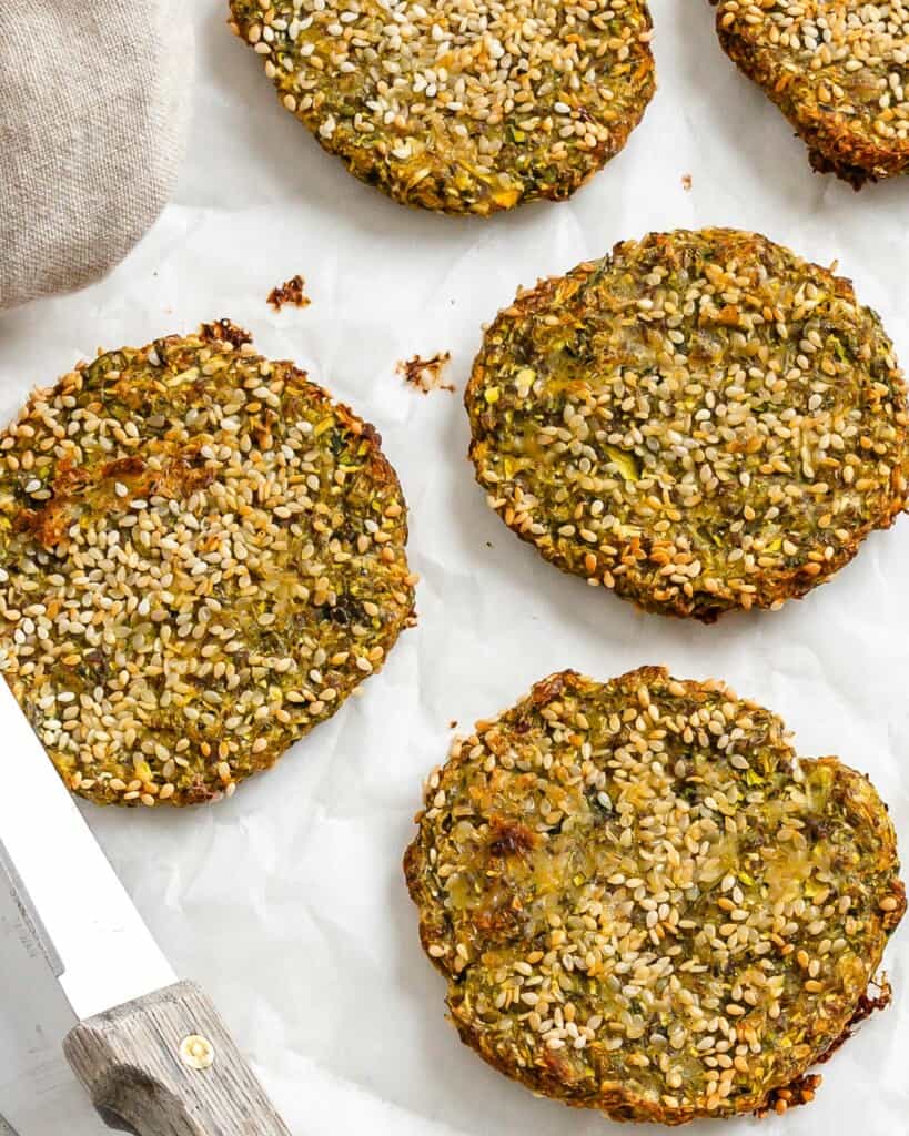 completed Vegan Baked Zucchini Fritters against a white surface