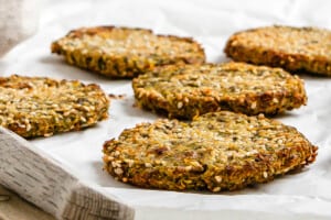 completed Vegan Baked Zucchini Fritters against a white surface