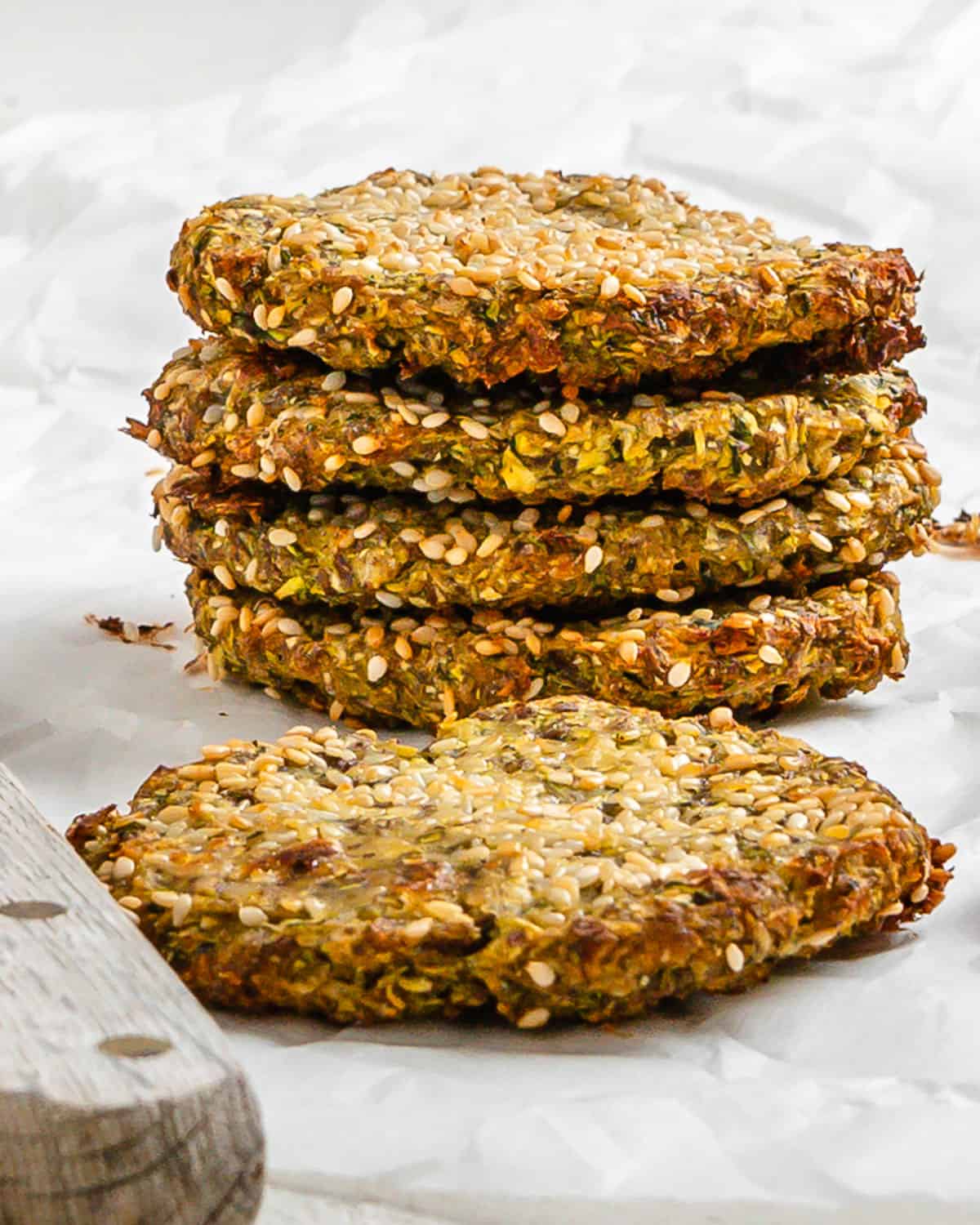 completed stack of Vegan Baked Zucchini Fritters against a white surface