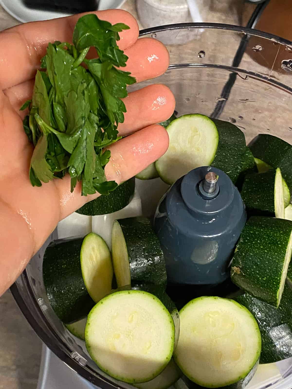 process of adding parsley to food processor