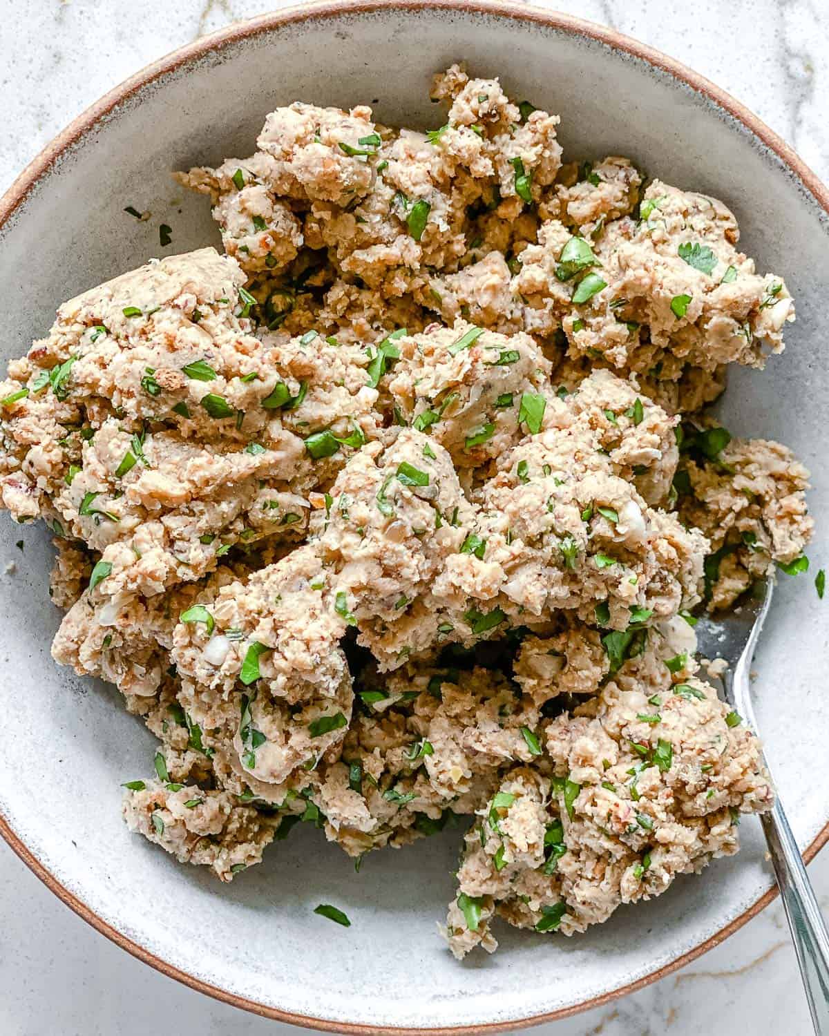 process of mashed mixture of White Bean Burgers in a white bowl