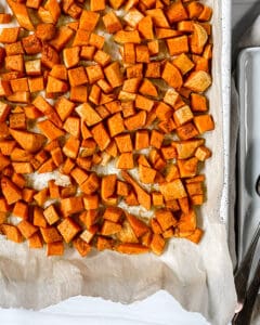 process showing cooked roasted butternut squash being cut into cubes against a white background