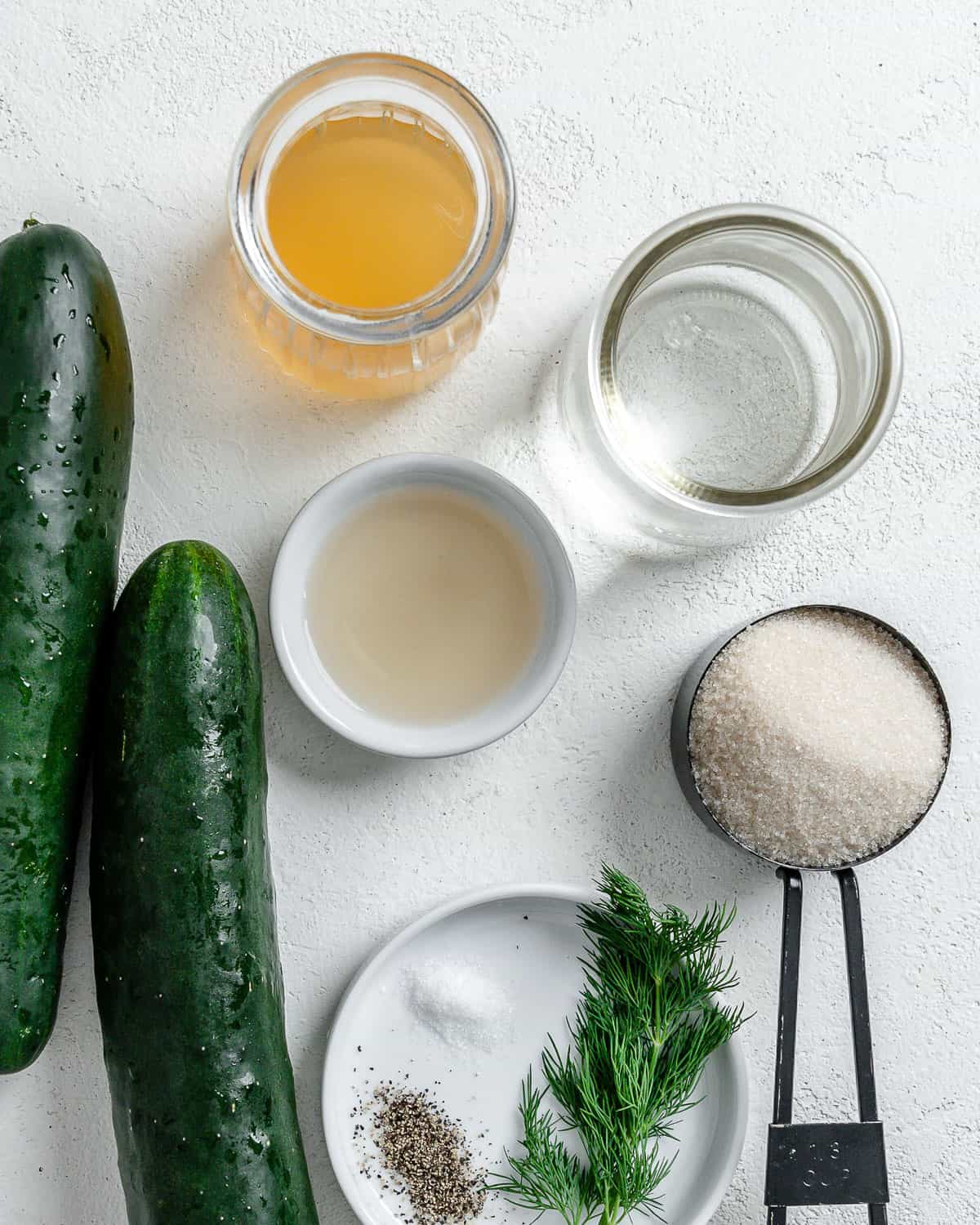 ingredients for marinated cucumber salad against a white surface