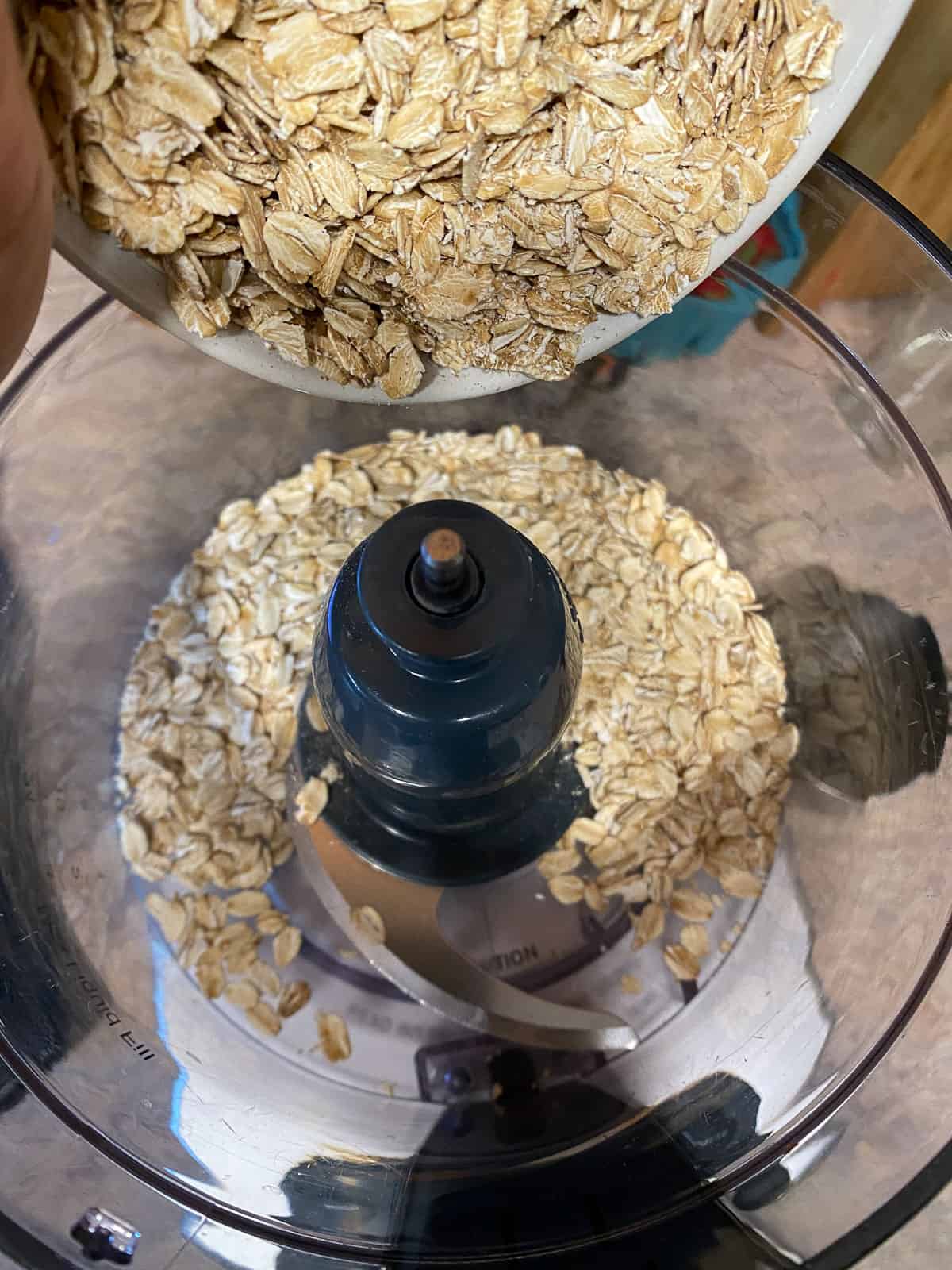 process shot of adding oats to food processor