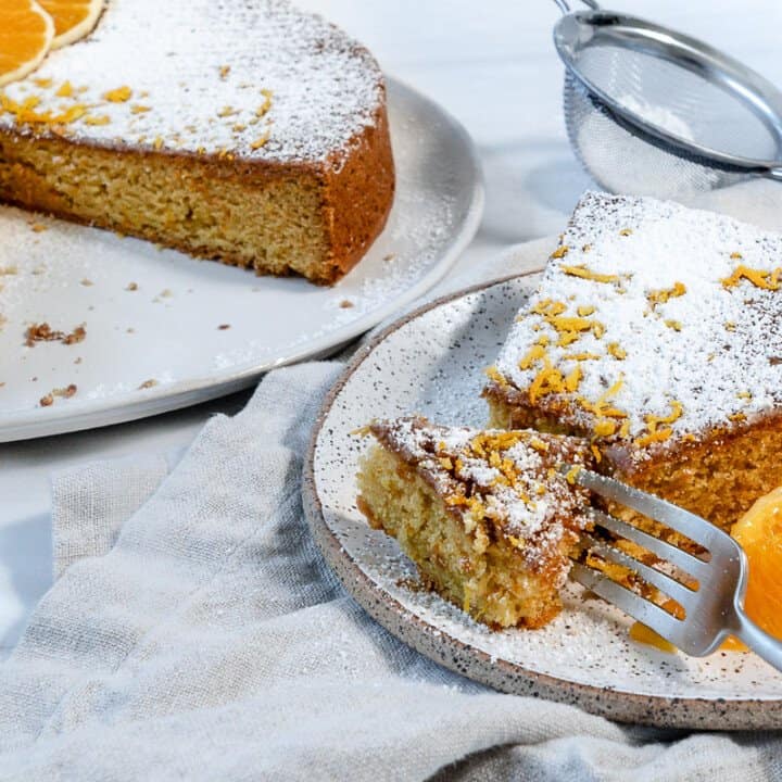 completed slice of Orange Olive Oil Cake against a white background