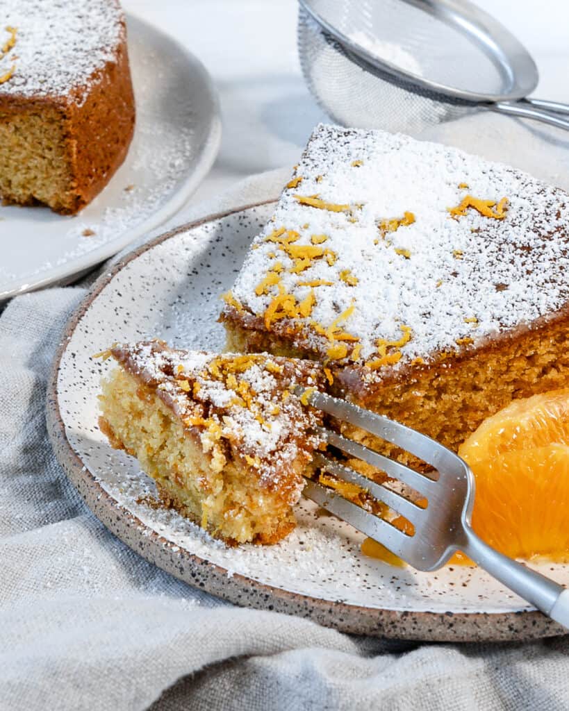 completed slice of Orange Olive Oil Cake against a white background