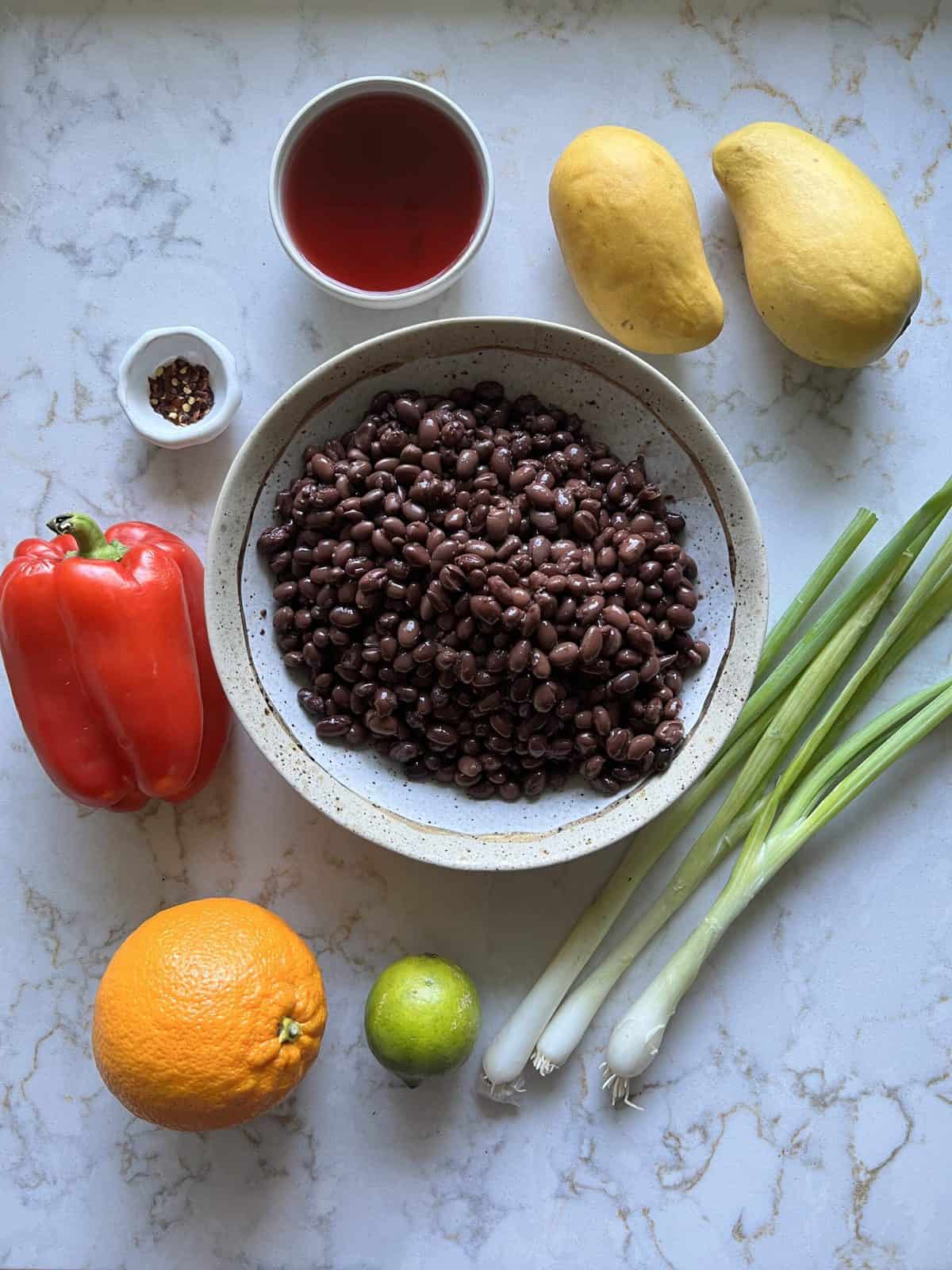 ingredients for Mango Bean Salad against white surface