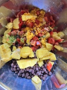 chopped ingredients for Mango Bean Salad mixed in bowl