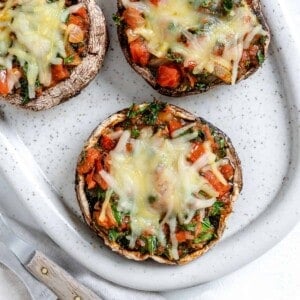 completed Portobello Mushroom Pizzas in a white serving tray