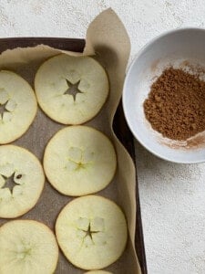 sliced apples on baking tray alongside mixed spices