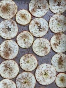 spices spread out on apples on baking tray