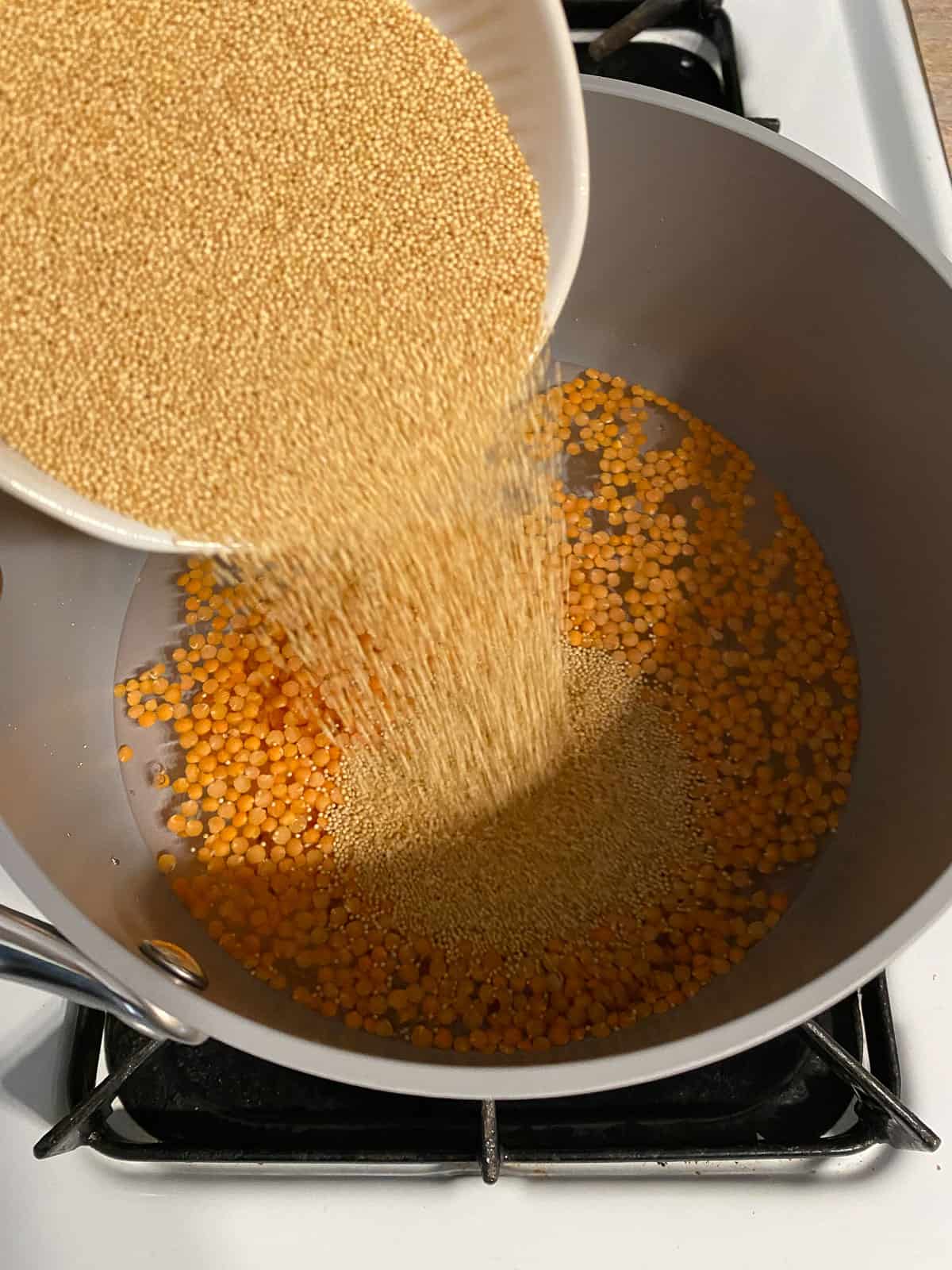 process of adding lentils to bowl