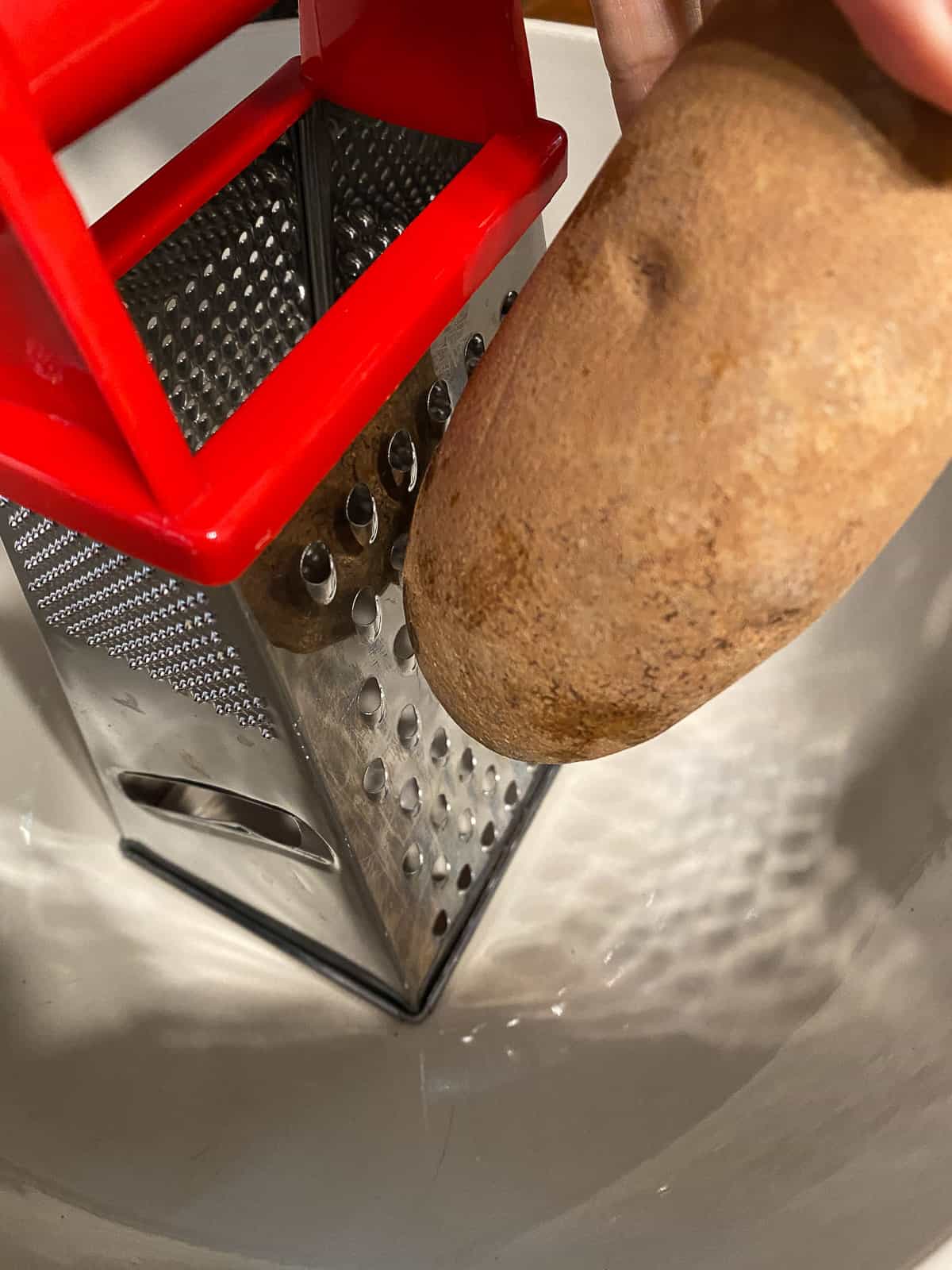 process shot of grating potato