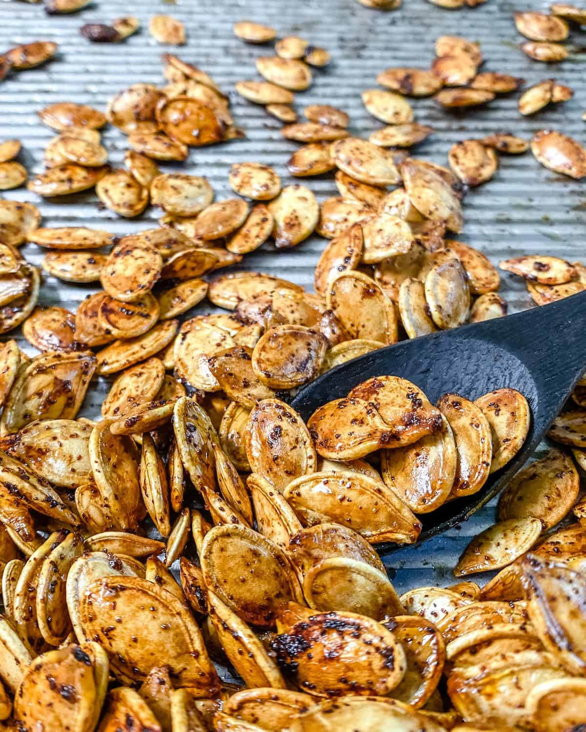 completed roasted ،y pumpkin seeds on a tray