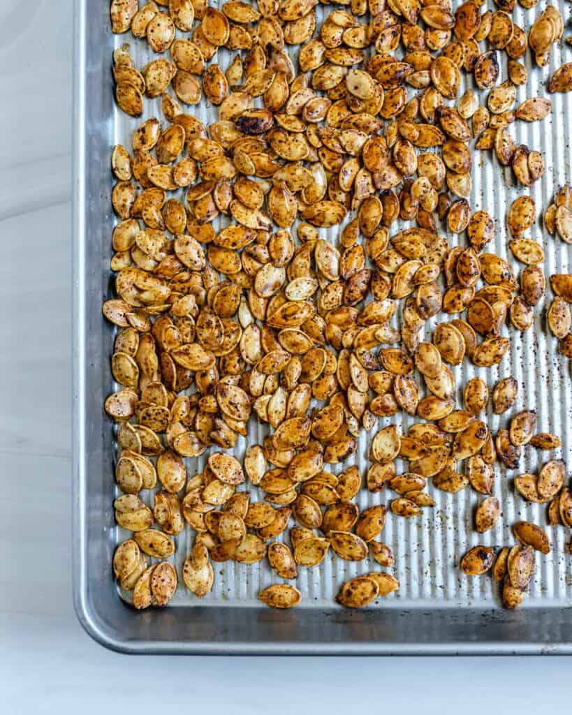 completed roasted spicy pumpkin seeds on a tray