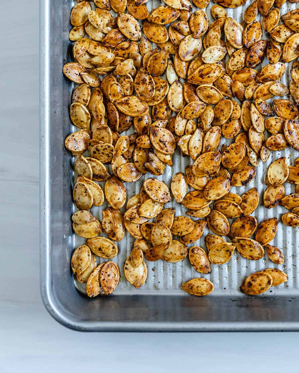 completed roasted spicy pumpkin seeds on a tray