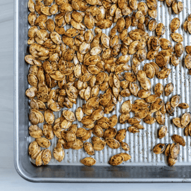 completed roasted spicy pumpkin seeds on a tray