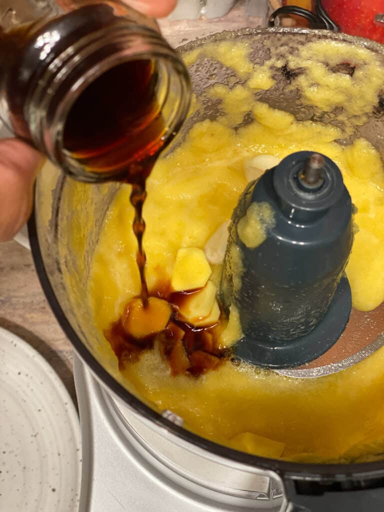 process shot of adding soy sauce to food processor
