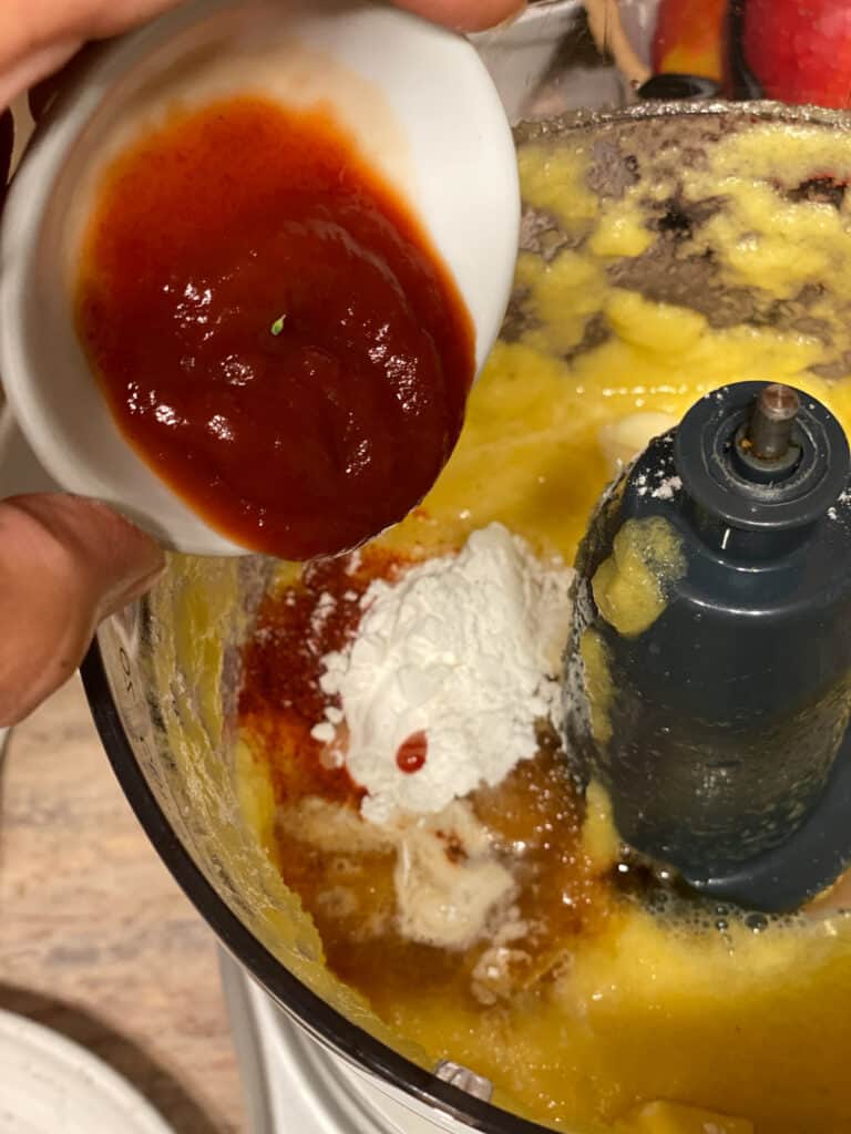 process shot of adding ketchup to food processor