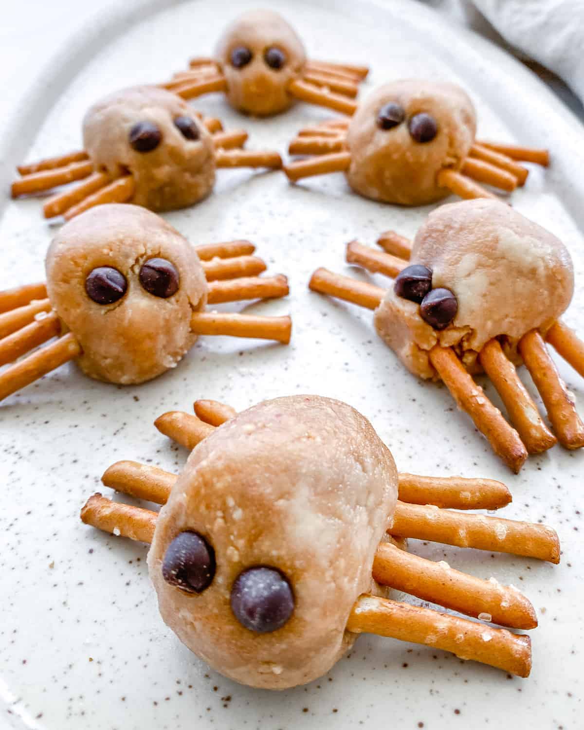 completed Halloween Peanut Butter Spiders on a white speckled tray