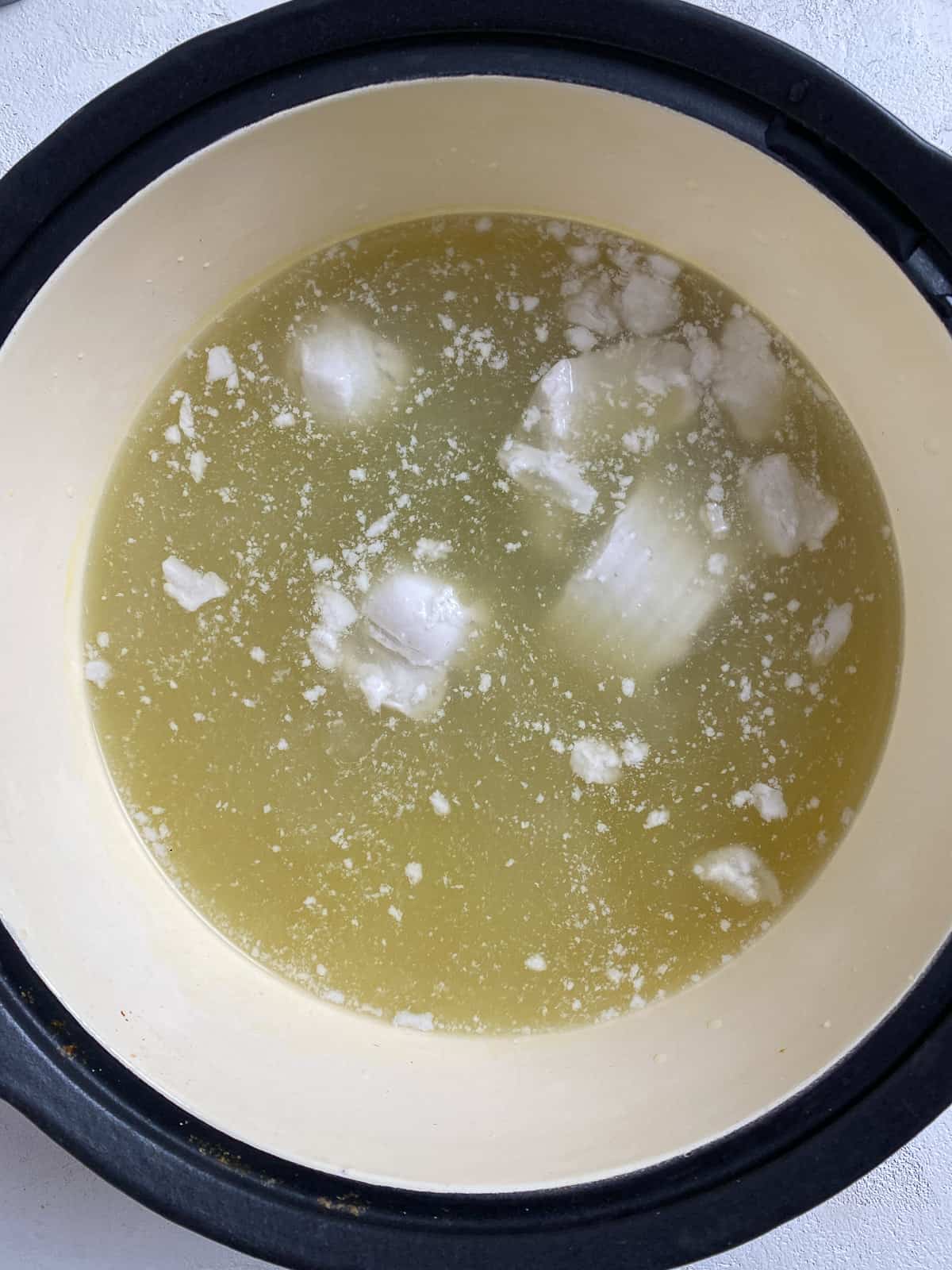 process of veggie broth and coconut milk in a pan