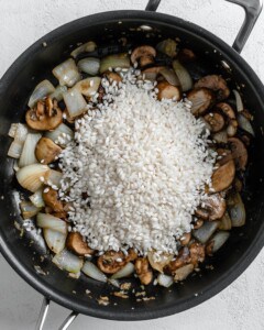 process of adding rice to black skillet