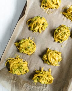 process of broccoli and onion pakora on a baking sheet prior to being baked