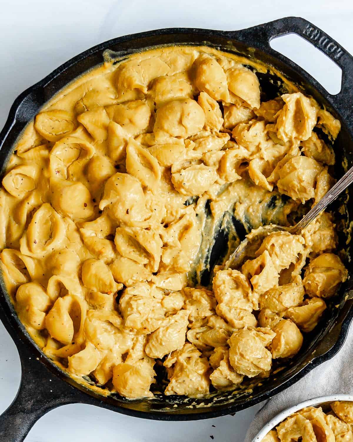 completed Butternut Squash Mac n’ Cheese in a skillet against a white background