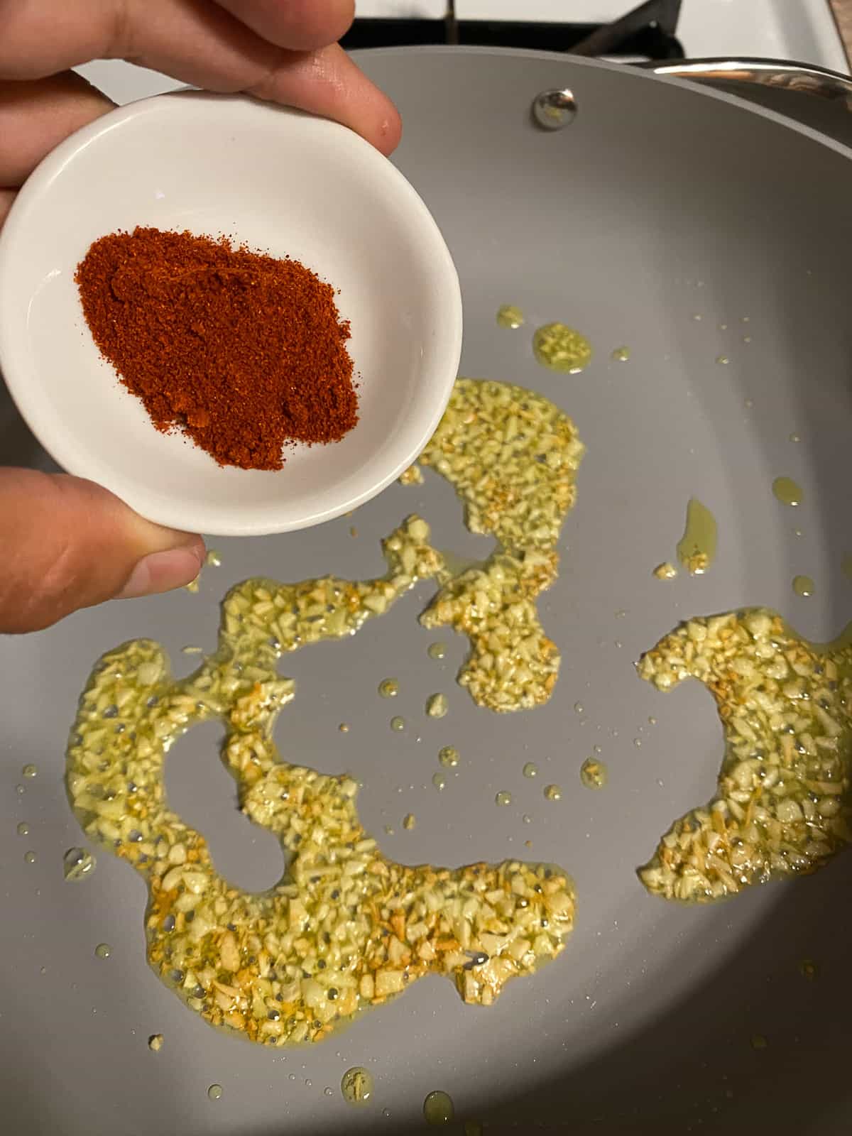 process of adding paprika to pan