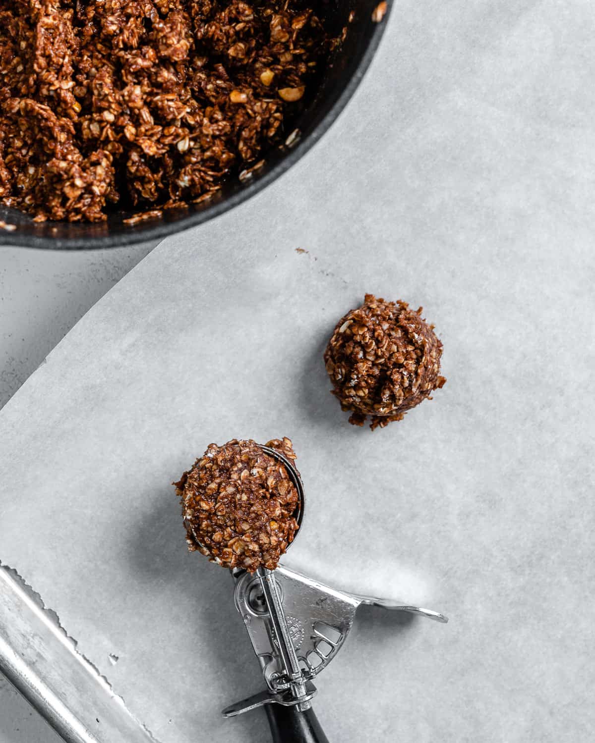 process shot of scooping cookie mixture onto baking sheet