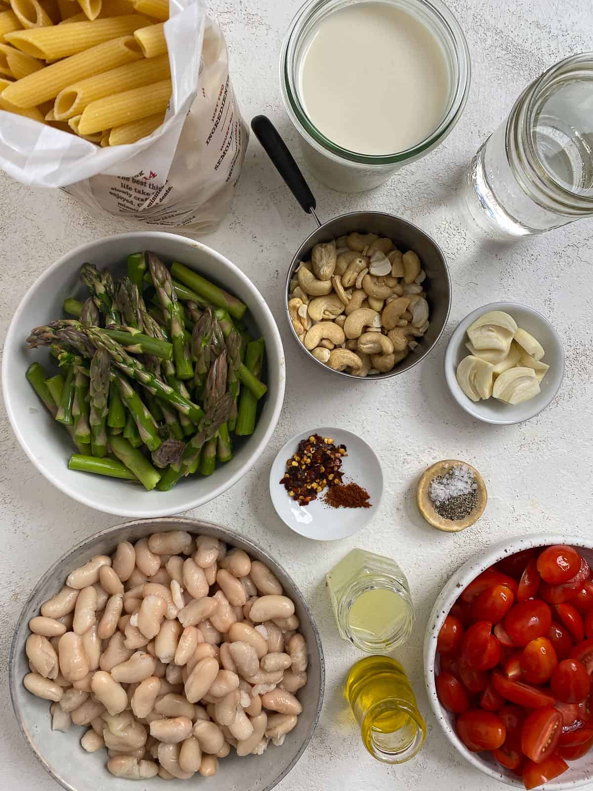 ingredients for Vegan Pasta Primavera Recipe measured out on a white surface