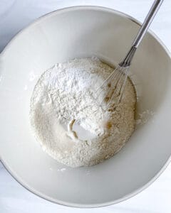 process of vanilla scones ingredients in a white bowl