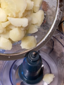 process shot showing potatoes before being added into food processor