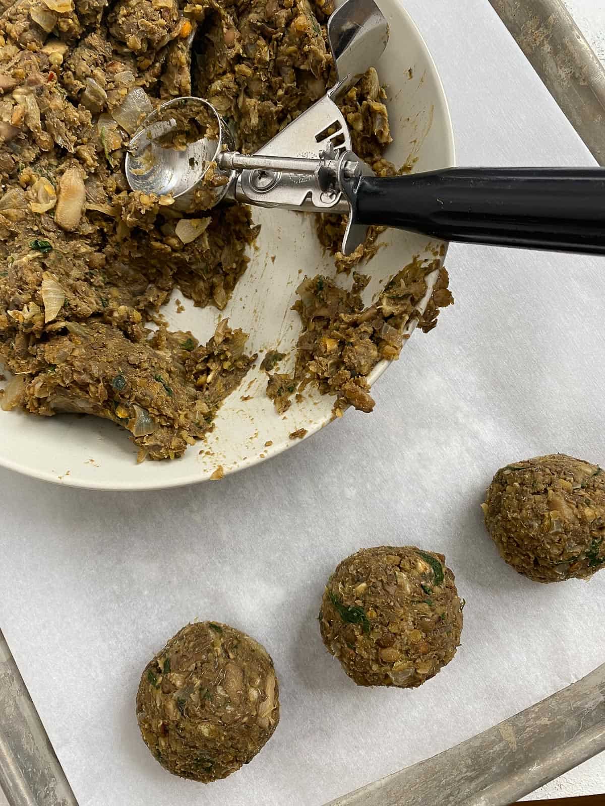 process shot of creating balls from lentil meatball mixture