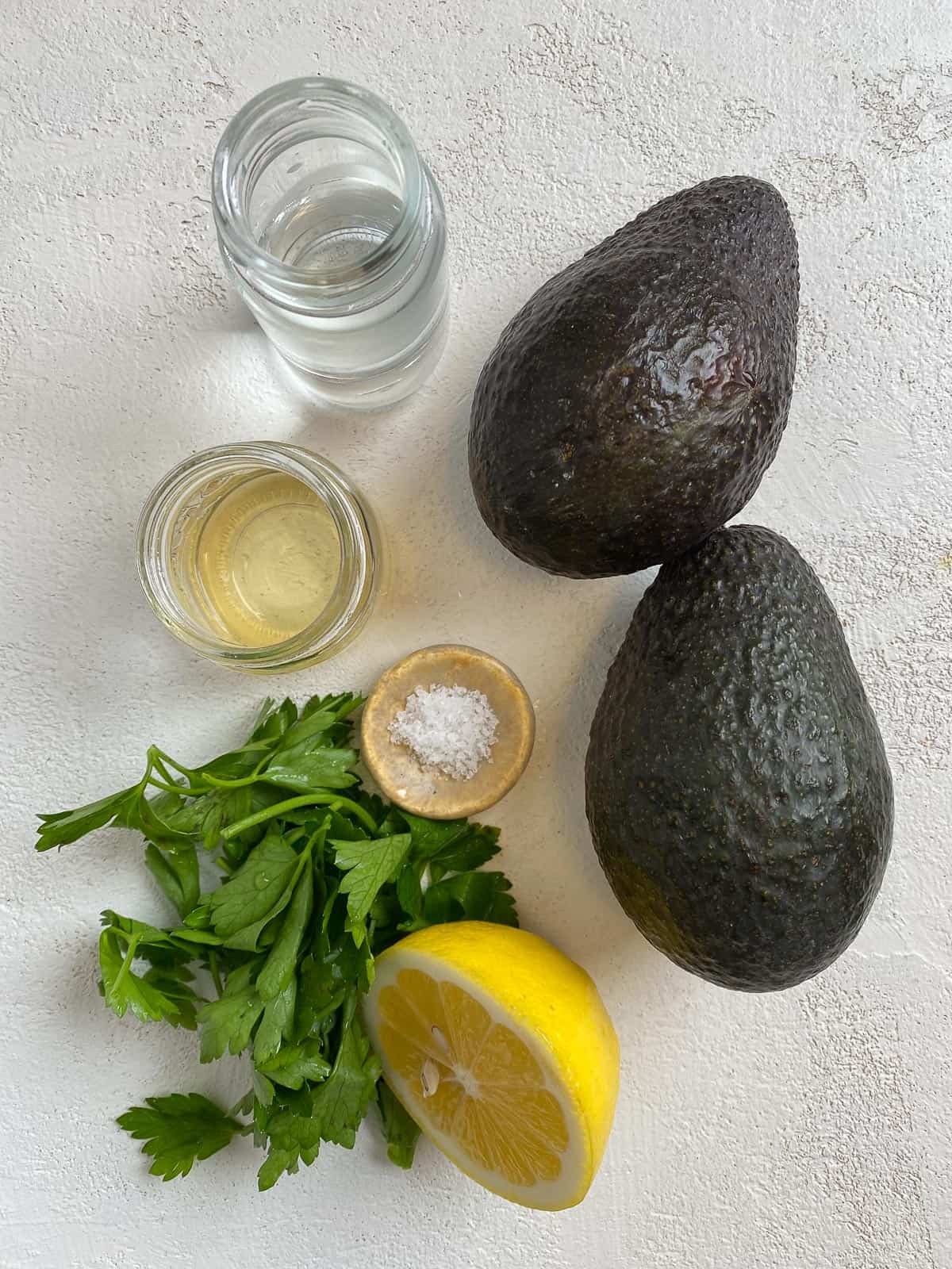 ingredients for Avocado Cream on a white marble surface