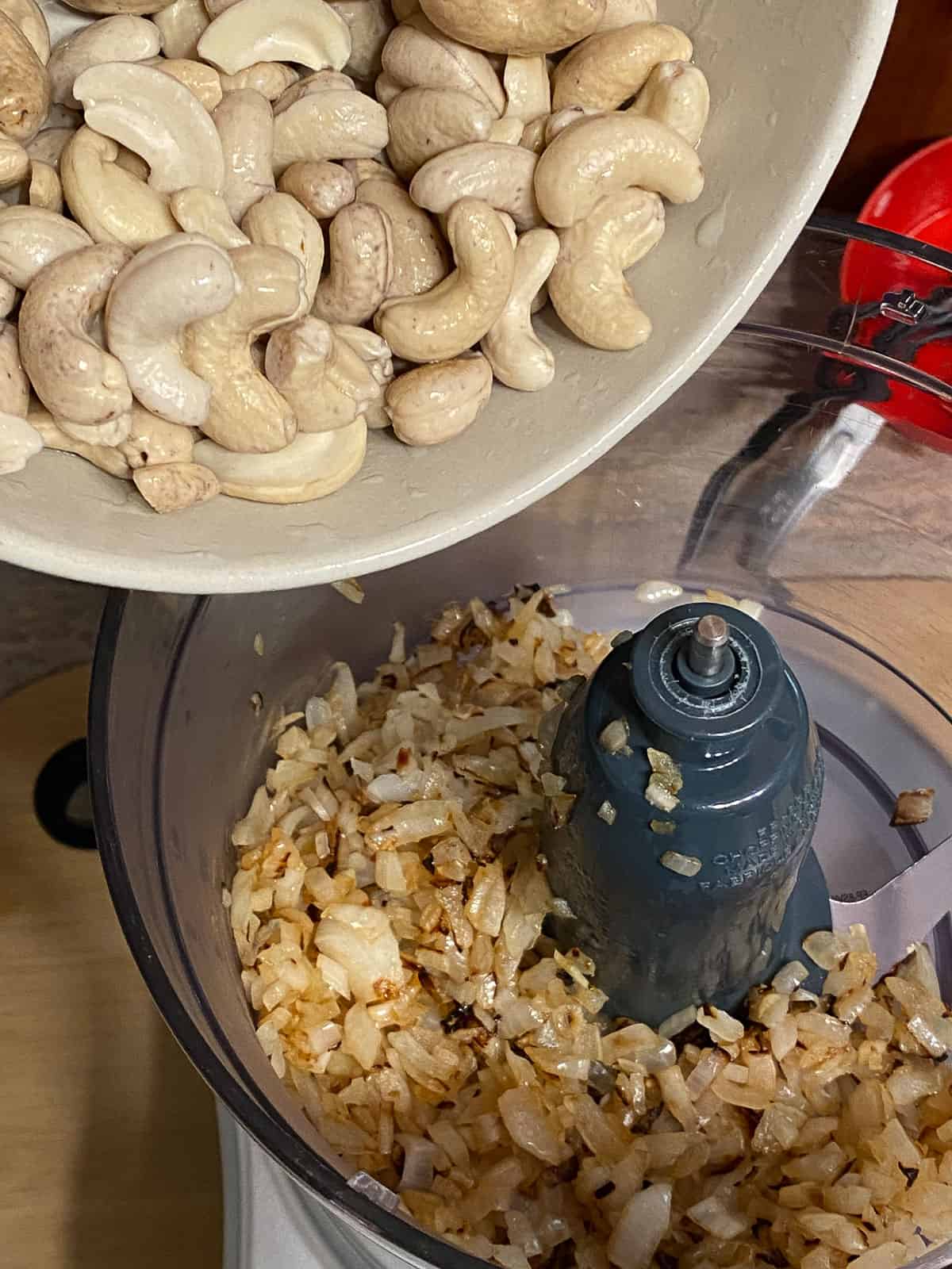 process shot of adding cashews to food processor