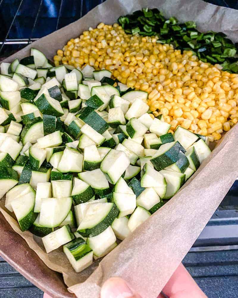 chopped ingredients in a baking sheet against a white background