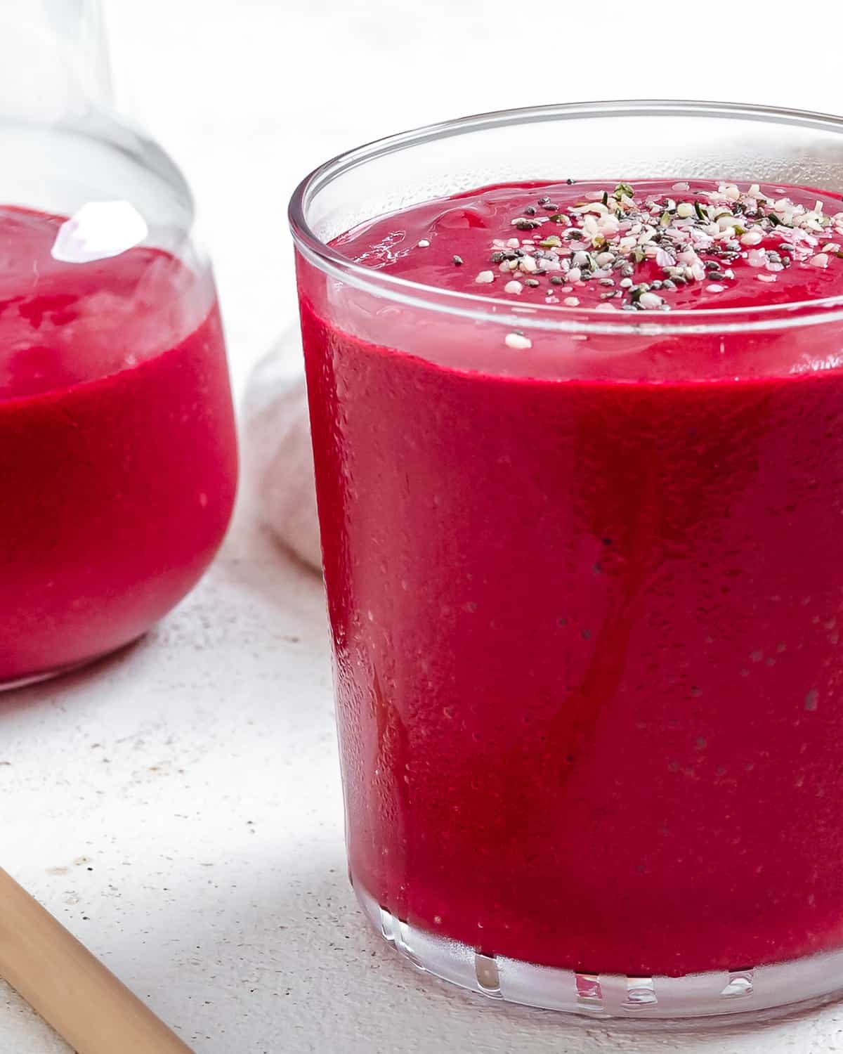 two completed Banana Beet Smoothies in a glass cup against a light background