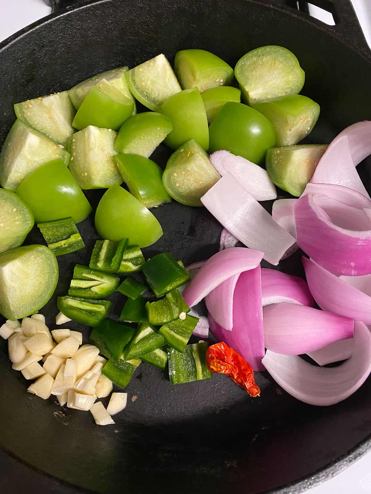 ingredients for Stovetop Tomatillo Salsa added to a pan