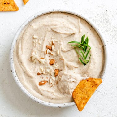 completed Vegan Bean Dip in a white bowl against a white background